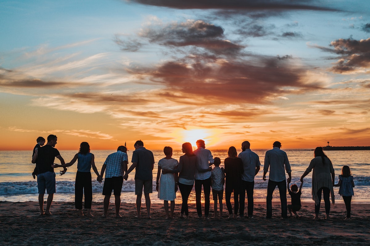 An extended family together at sunset, representing funeral cover from New Leaf Financial Solutions