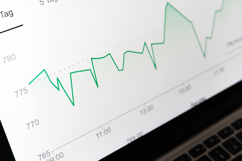 An upward trending investment growth chart on a laptop screen